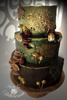 a three tiered cake decorated with flowers and leaves