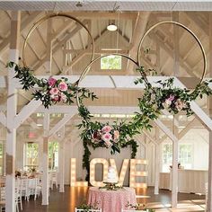 a wedding reception setup with flowers and greenery