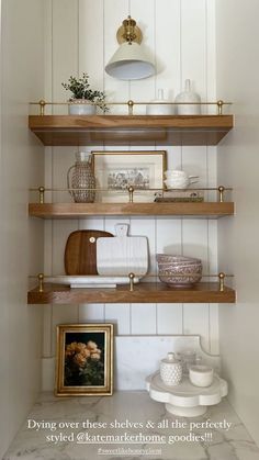 the shelves in this kitchen are filled with dishes and other things to put on them