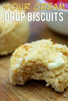 a close up of a biscuit on a table with the words sour cream drop biscuits