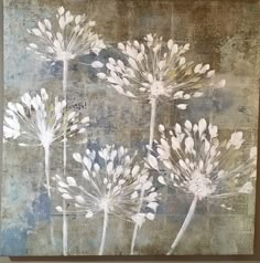 three white flowers on a blue and brown background with the words,'dandelion '