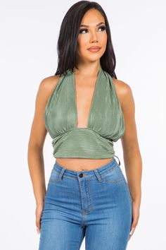 A crop top featuring a back-tie halter strap that crosses at the neck, fitted bodice, cropped length and luxe plisse fabrication.Fabric: 100% Polyester Made in: Los Angeles, USA Size Bust Waist Hips XS 32 24 - 25 33 - 34 S 34 - 35 26 - 27 35 - 36 M 36 - 37 28 - 29 38 - 40 L 38 - 39 30 - 31 42 - 44 Spring Triangle Top Halter For Night Out, Spring Triangle Halter Top For Night Out, Triangle Halter Top For Night Out, Versatile Backless Halter Top With Tie Back, Versatile Halter Top For Spring, Triangle Crop Top For Night Out, Backless Crop Top For Spring Night Out, Spring Halter Neck Top For Night Out, Chic Triangle Halter Top For Spring