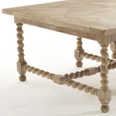 an old wooden table that has been turned into a coffee table with beads on the legs