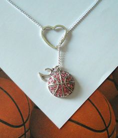 a necklace with a basketball and heart on it