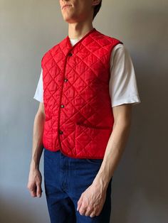 Quilted Waistcoat / Quilted Vest / Size M / 1990s  This vintage quilted vest wonderful condition! - made in Italy - ERA - circa 1990's - color - red - 2 outside pockets - 4 stud buttons at front - material - 100% polyester - label size - M (watch measurements) FLAT Measurements: Shoulders: 39cm Chest (underarm to underarm): 50cm Length(back): 62cm Pay your attention to that  most antique items have been used and may have minor flaws. Please , read the description carefully and check the measurem Quilted Vest For Winter Streetwear, Classic Red Sleeveless Outerwear, Casual Quilted Cotton Vest, Classic Red Winter Vest, Vintage Winter Vest Outerwear, Vintage Spring Vest Outerwear, Retro Red Cotton Vest, Red Retro Cotton Vest, Red Cotton Retro Vest