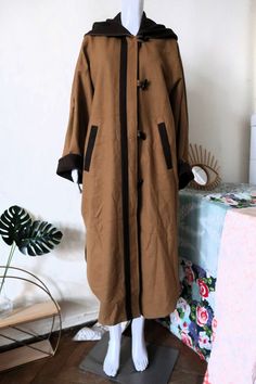 Stunning True Vintage Austrian trachten coat from the 1990s. Made from a high quality medium heavy milled wool fabric in toffee with brown details. Generous cut, which makes it look like a cape. Extravagant super wide batwing sleeves - the sleeves can either be worn long or turned up and shortened. Two deep pockets, large comfortable and lined hood. Side vents, rounded hem. Looks great combined with a warm sweater, a pair of jeans and ankle boots! BRAND: Original Dachstein  ERA: 1990s COLOR: Cam Brown Hooded Wool Coat For Winter, Coat Cape, Brown Trim, Warm Sweater, Cape Coat, Warm Sweaters, Wool Fabric, Batwing Sleeve, True Vintage