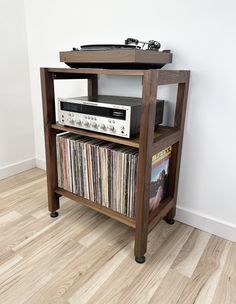 an old record player is sitting on top of a shelf