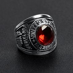 The United States Military Red Stone Marine Corp Ring from our Military Collection is custom molded and cast with a premium blend of surgical stainless steel that offers enhanced durability, even after exhaustive wear. The stainless steel Red Stone US Marine Corp Ring features a red stone centerpiece with a detailed designs on both sides of the ring. This ring is a bulkier styled ring that is great for men who want a classic everyday ring or a veteran who wants a memorable keepsake to help them Formal Red Engraved Ring With Polished Finish, Red Metal Ring Jewelry For Anniversary, Red Engraved Jewelry For Anniversary, Engraved Red Ring Jewelry, Engraved Red Round Signet Ring, Red Engraved Rings For Promise, Durable Classic Stainless Steel Jewelry, Classic Red Engraved Ring, Red Oval Engraved Ring With Polished Finish