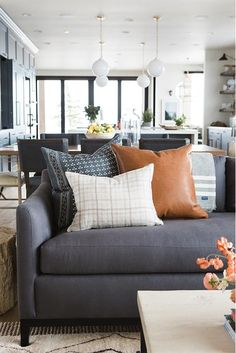 a living room filled with furniture and pillows