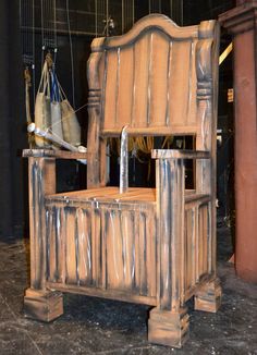 an old fashioned wooden chair sitting on top of a floor