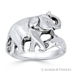 an elephant ring with two smaller elephants on it's back and the other side