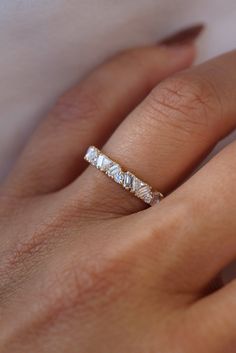 a woman's hand with a diamond ring on it