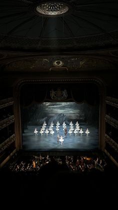 an image of people performing on stage in the dark