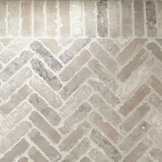 a white and grey herringbone tile wall