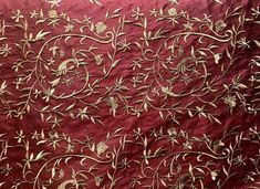 an embroidered red cloth with gold flowers on it