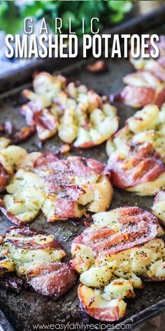 grilled smashed potatoes on a baking sheet with text overlay that reads garlic and smashed potatoes