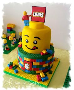 a lego cake made to look like the face of a person with a sign on top