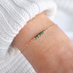 "This hand made bracelet showcases a stunning selection of raw emerald rondelles, centered on a dainty but durable chain in your preferred finish. This makes a wonderful gift for someone with a May birthday. Bracelet Size Guide: Petite: 6.5\"-7\"  Average (fits most wrists): 7-8\"  Large: 8-8.5\" To find your bracelet size, simply measure the circumference of your wrist by wrapping a string around it and measuring the length of the string. If you are shopping for someone else and are unsure of what size to order, you may order an adjustable bracelet. How to Order: * Using the first drop down menu, select your preferred bracelet length and finish * In the second drop down menu, select your extender chain preferences * Select \"Add to Cart\". Triple check your shipping address and billing in Minimalist Jade Jewelry For May Birthstone, Dainty Green Beaded Bracelets For Everyday, Minimalist Green Beaded Bracelet For Everyday, Adjustable Minimalist Beaded Bracelets For May Birthstone, Delicate Green Bracelet As Gift, Green Hand Wrapped Beaded Bracelets For Everyday, Minimalist Adjustable Emerald Jewelry, Dainty Green Bracelets For Everyday, Dainty Green Everyday Bracelets