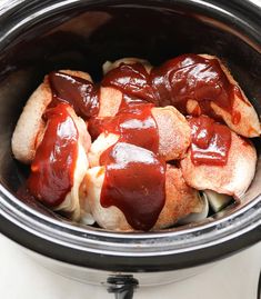 crock pot filled with meat covered in ketchup