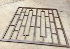 a metal grate sitting on top of a cement floor