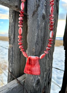 This beautiful necklace was made using a wonderful variety of red spiny oyster shell beads. The spiny oyster pendant is 1 1/2" wide and 2" height Length is 25" $150 Item 744B Artisan Red Jewelry With Large Pendant, Unique Red Necklace With Large Pendant, Red Bohemian Shell Necklace For Gift, Handmade Red Shell Necklace Gift, Handmade Red Shell Necklace For Gift, Red Coral Pendant Necklace, Unique Single Strand Red Beaded Necklace, Unique Red Single Strand Jewelry, Unique Red Single Strand Beaded Necklace