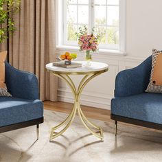 a living room with two chairs and a table in front of a window on a rug