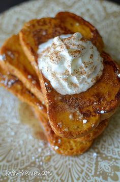 three pieces of french toast topped with whipped cream