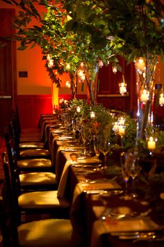 an image of a table setting with flowers and candles in vases on the tables