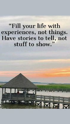 a pier with people sitting on it and the quote fill your life with experiences, not things have stories to tell, not stuff to show