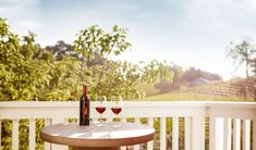 two glasses of wine sitting on top of a table