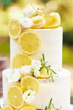 a white cake with lemons and flowers on it