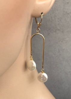 Shop Arch Earrings Gold. Real pearl earrings will add a perfect touch of flair to your outfit! These modern pearls drop earrings are made from: - 18K Gold plated connectors - White freshwater coin pearls - about 10mm-it can be small variations - Gold Filled ear wires-French hook Freshwater pearls are slightly different in size, so it makes every pair unique. Modern statement earrings u shaped are 2 7/8 inches long and light. Bohemian Jewelry will make a great gift! Your order will be mailed with Teardrop Clip-on Chandelier Earrings Gift, Dangle Pearl Drop Earrings As Gift, Pearl Drop Dangle Plug Earrings As Gift, Adjustable Clip-on Drop Earrings Jewelry, Adjustable Clip-on Drop Earrings, Adjustable Dangle Pearl Earrings, Adjustable Pearl Drop Earrings For Jewelry Making, Adjustable Dangle Pearl Earrings With Ear Wire, White Dangle Pearl Clip-on Earrings