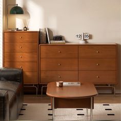 a living room scene with focus on the coffee table and dresser in the foreground