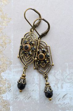 VINTAGE ELEMENTS Unique Jewellery, Handmade from Vintage Inspired Original Designs Art Nouveau, Edwardian, Victorian style antiqued Gold Brass, Black Drop  Filigree Earrings with Black Crystal Flower detail. These earrings are made with antiqued brass  leverback earwires and measure 5.5cm from the top of the earwires. Art Noveau Earrings, Black And Gold Jewelry, Jewelled Headpiece, Antique Gold Earrings, Faberge Jewelry, Headpiece Jewelry, Glass Drop Earrings, Edwardian Jewelry, Filigree Earrings