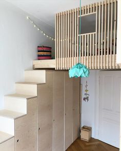 there is a room with some stairs that are made out of plywood planks