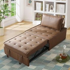 a brown leather chaise lounger sitting on top of a rug