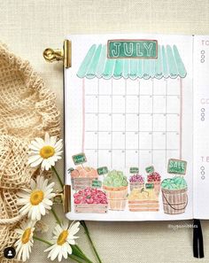 an open planner with flowers next to it