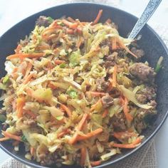 a bowl filled with meat and veggies on top of a white table cloth