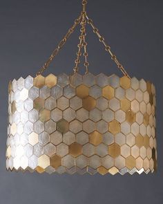 a chandelier hanging from a chain with hexagonal tiles on it