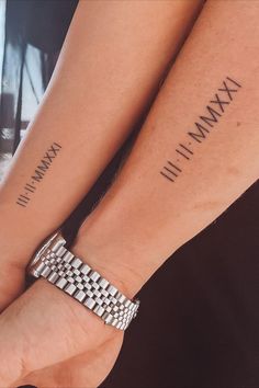 two people holding hands with tattoos on their arms and wristbands that read maximum