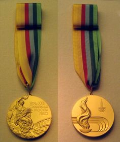 two medals are shown side by side on the wall, one is gold and the other is silver