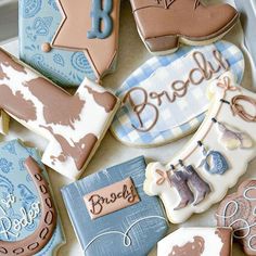 decorated cookies in the shape of cowboy boots and boots with names on them, are shown