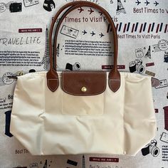 Color: Cream Key Features: Foldable, Compact Size Opened: 17.5w X 9h X 6d Exterior Material: Nylon Closure: Zipper, Snaps Gold Decorative Zipper New Longchamp Bag, Dumpling Bag, Longchamp Bags, Visit Paris, Paris Travel, Bag Lady, Key, Exterior, Shoulder Bag