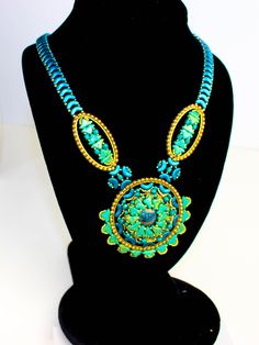 You'll feel like a Caribbean Queen in this vibrant hand beaded necklace! Beautiful shades of turquoise colored uniquely shaped beads create the focal medallion for this piece. The necklace component measures 22 inches, including the 3-inch Rolo chain extension. **If you would prefer a 19-inch length, just let me know & I will remove the extender The medallion measures 3 inches in diameter & and makes a stunning focal point for the necklace. An aqua & bronze center stone cabochon was bead-wrapped Queen Necklace, Caribbean Queen, Hand Beaded Necklace, Anchor Necklace, Shades Of Turquoise, Beaded Wraps, Cabochons Stones, Marine Blue, Large Ring