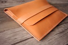 a leather wallet sitting on top of a wooden table