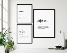 three black and white framed posters on the wall above a table with a potted plant