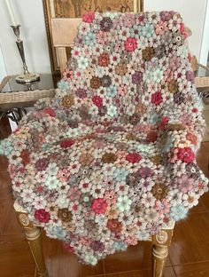 a crocheted chair is sitting on the floor