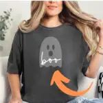 a woman wearing a black shirt with an orange arrow in the middle and a ghost on it