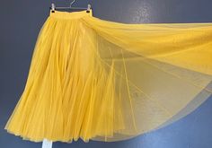 yellow tulle skirt wedding party vocation skirt size M  Details :  Color: yellow Size: M  Elastic waist  Material: Tulle lining inside  Measurements: *Waist: 12 inches across lay flat ( 24 inches around); can stretch to 19 inches wide (38 inches around). *Skirt length: 32 inches long Weight:  Appropriate 1 lb 5oz Care: Hand wash/Dry clean * Model's height is 5'7'' and waist is 28 inches, and is wearing size M  ---------------------------------------- Yellow Flared Party Skirt, Yellow Tulle Party Skirt, Yellow Tutu Skirt, Yellow Tulle Skirt, Yellow Tutu Skirt Kids, White Tulle Skirt, Rainbow Skirt, Dance Skirt, White Tulle