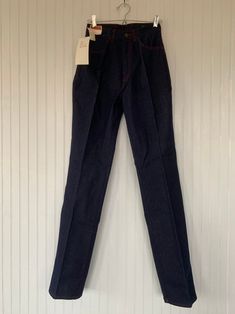 "Rare NWT Vintage Early 80s High Waisted Dark Denim Blue Jeans, by Hush Puppies. New condition and unworn with original tags. Super high rise waist. Front & back pleated down center of leg. Dark denim with red stitching, embroidered back pockets with basset hound logo. Amazing Original condition with original store tags! Brand - Hush Puppies Condition - Original. Deadstock from the 80s, New with original tags 100% Cotton Made in Taiwan Machine Washable Vintage Size - 8 Size - 26\" waist Best Fitted High-rise Recycled Denim Jeans, Fitted Recycled Denim Bottoms For Fall, Fitted Full Length Rigid Denim Jeans, Fitted Full-length Denim Jeans, Fitted Medium Wash Recycled Denim Pants, Classic Fitted Recycled Denim Bottoms, Fitted Recycled Denim Bottoms With Standard Cut, Fitted Medium Wash Rigid Denim Pants, Red Full-length Denim Jeans